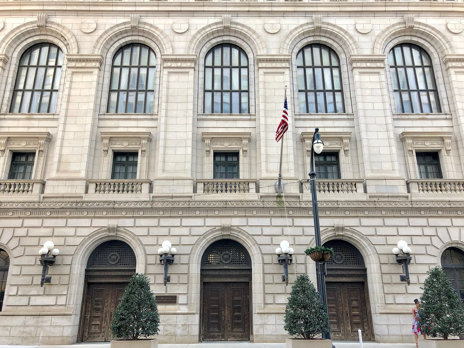 The columned stone facade of the Elbert P. Tuttle U.S. Court of Appeals Building in Atlanta under a clear sky.