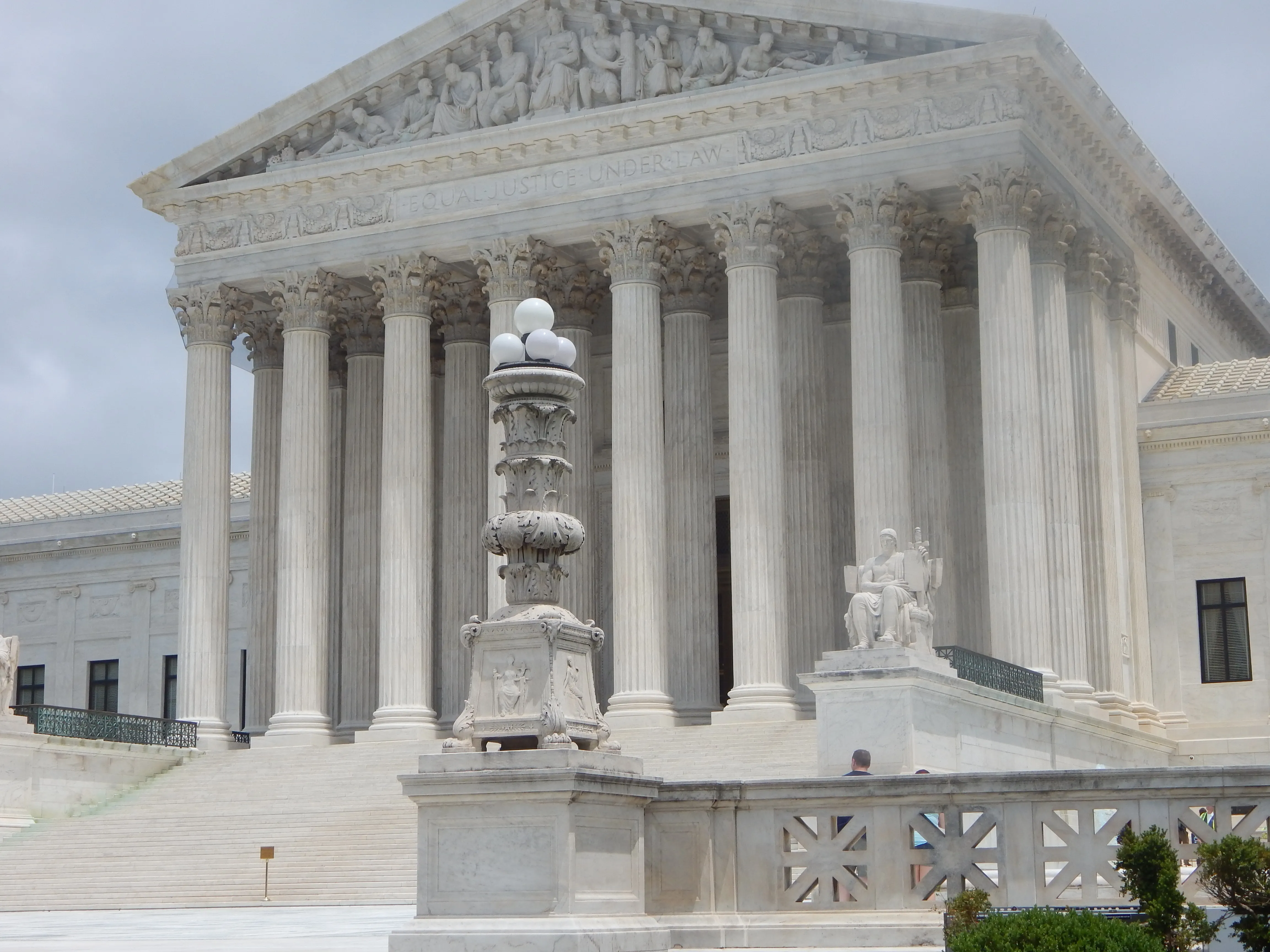 The exterior facade of the United States Supreme Court building in Washington, D.C., with marble columns and a triangular pediment