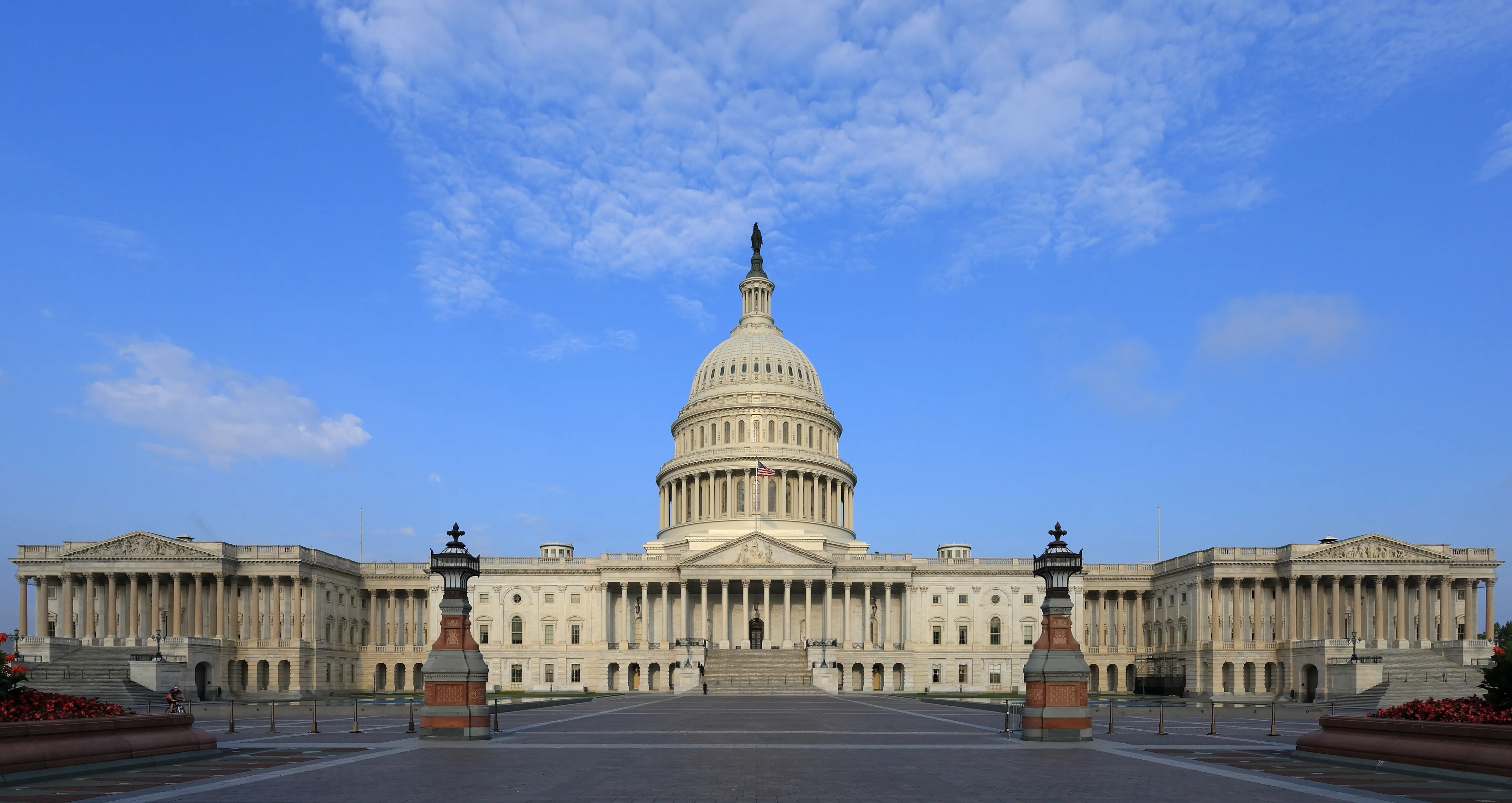 The east front of the United States Capitol building, with the dome and marble columns visible in daylight
