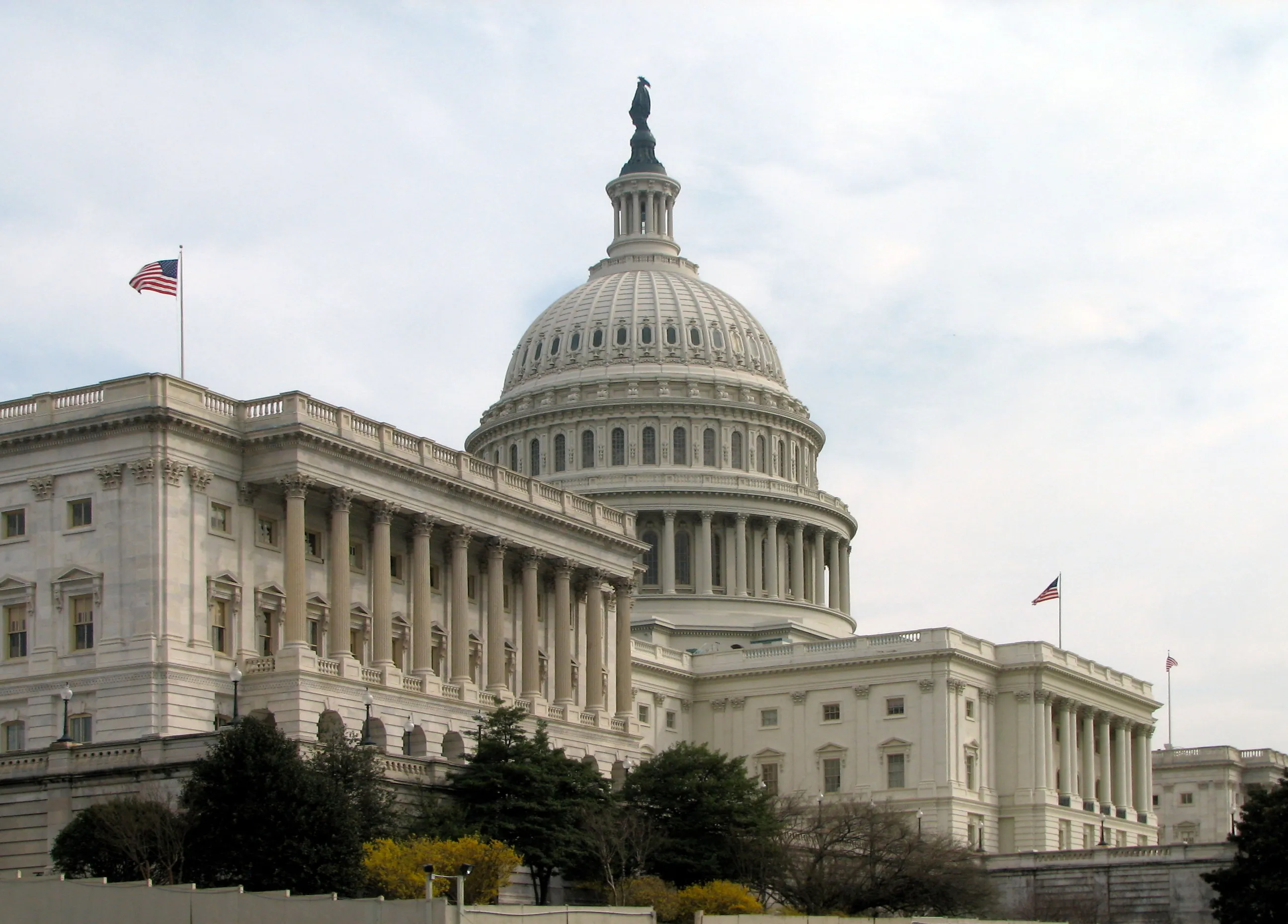 The Senate side of the U.S. Capitol, showing the north wing and dome under a clear sky.