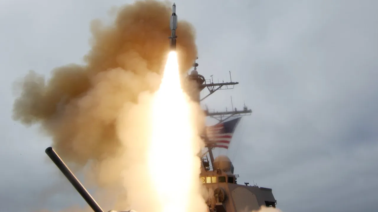 A U.S. Navy destroyer fires a Standard Missile interceptor, the rocket trailing flame and smoke above the deck.