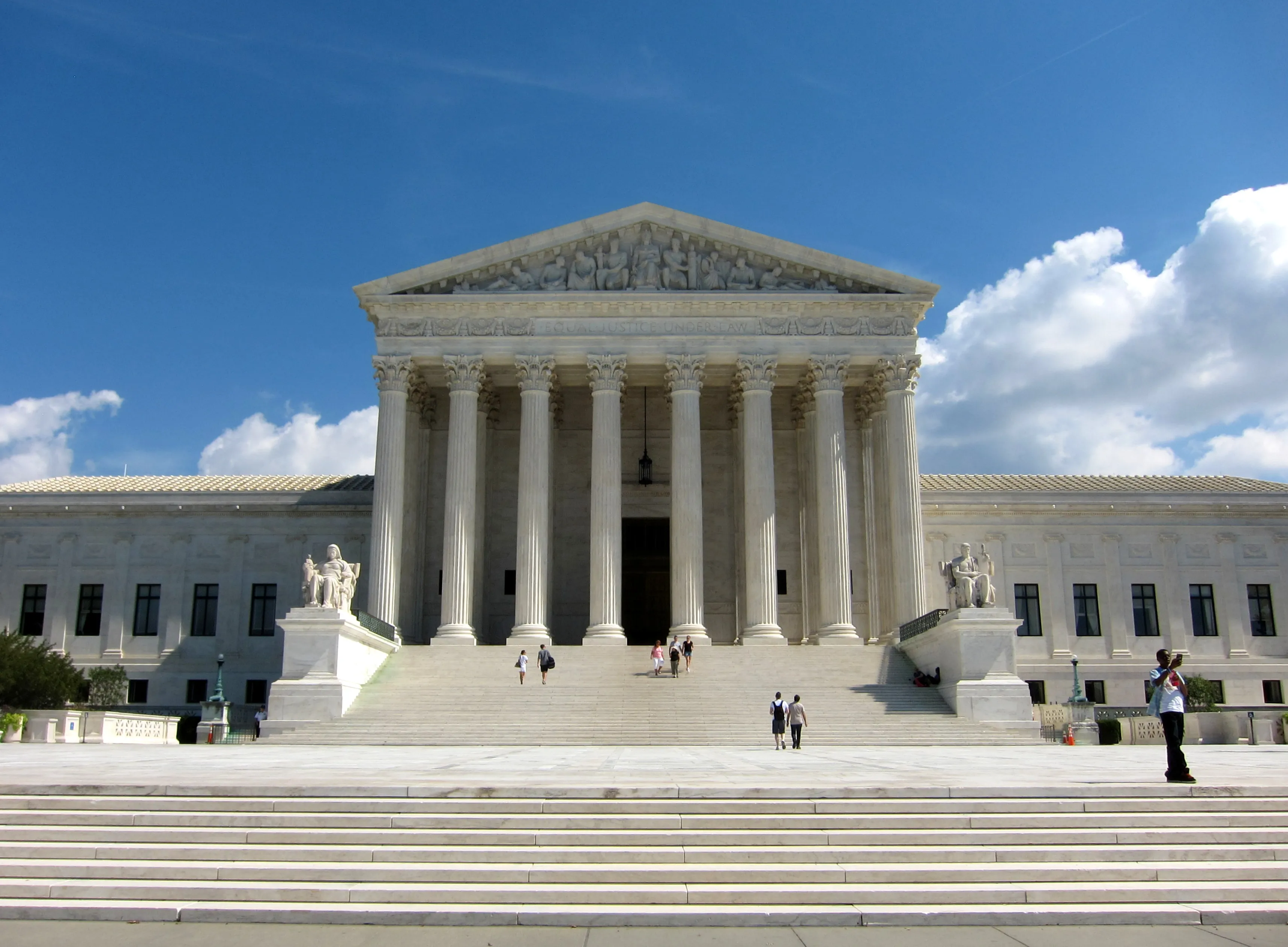 The west facade of the United States Supreme Court building in Washington, with its Corinthian columns and the inscription Equal Justice Under Law above the entrance.