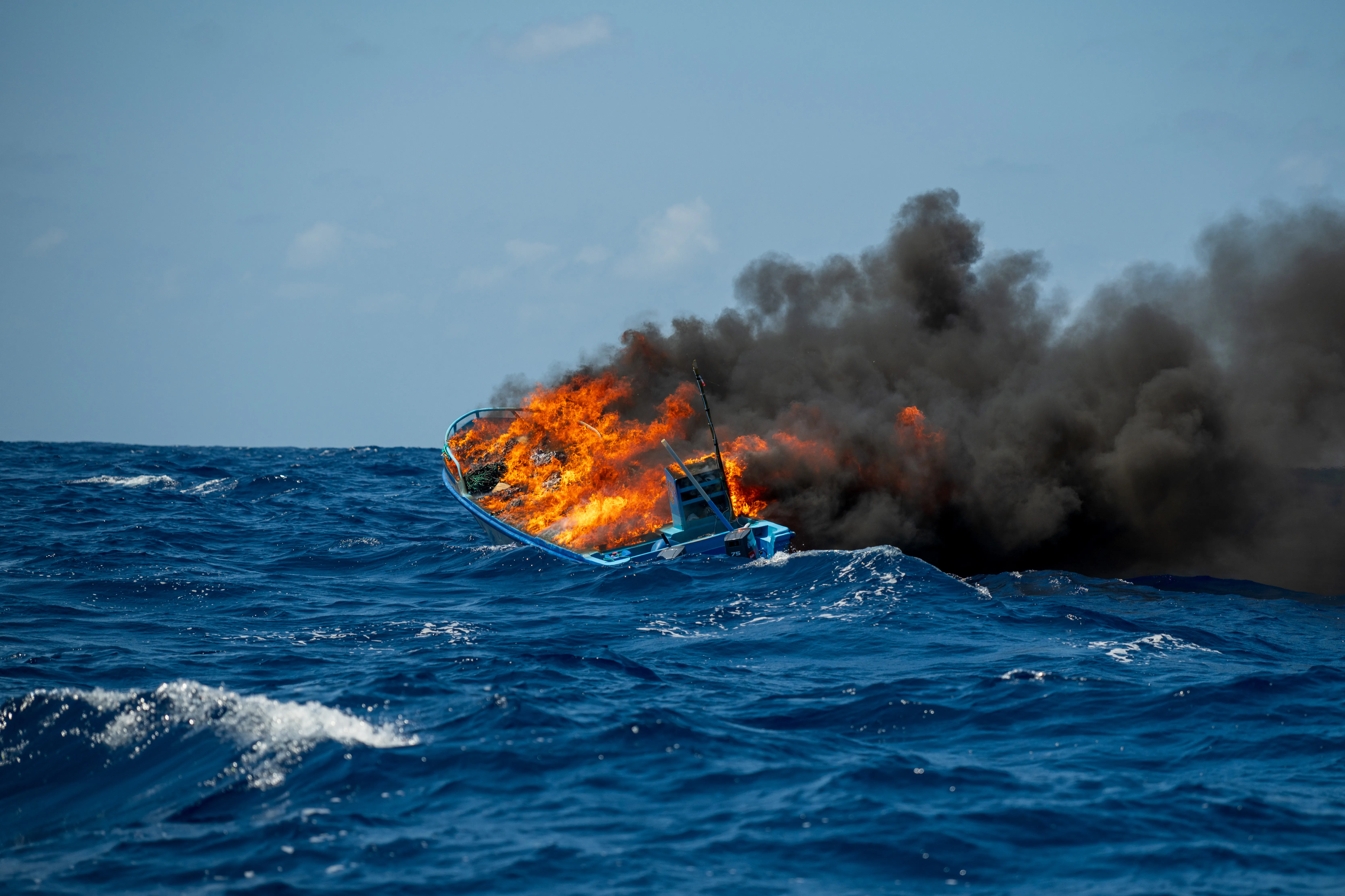 A vessel is scuttled in the eastern Pacific Ocean alongside a U.S. Coast Guard cutter following a drug interdiction operation