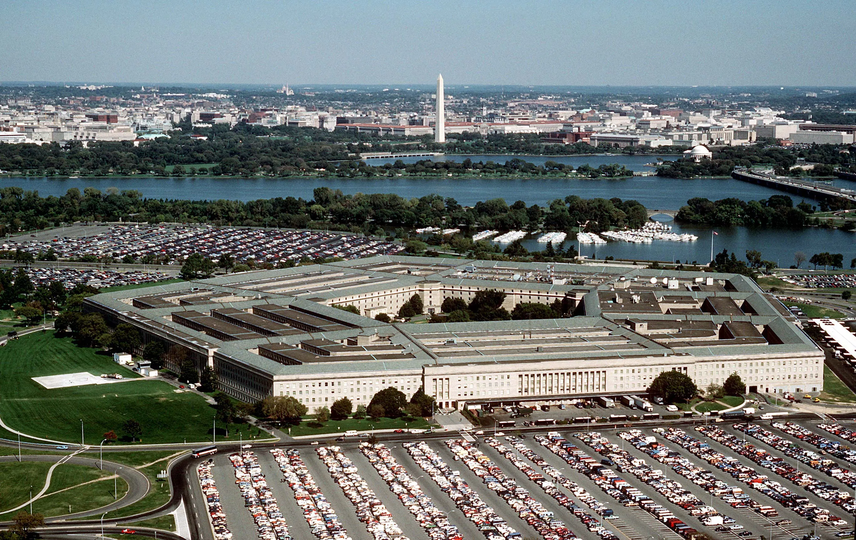 Aerial view of the Pentagon, the five-sided headquarters building, surrounded by parking lots and highways.