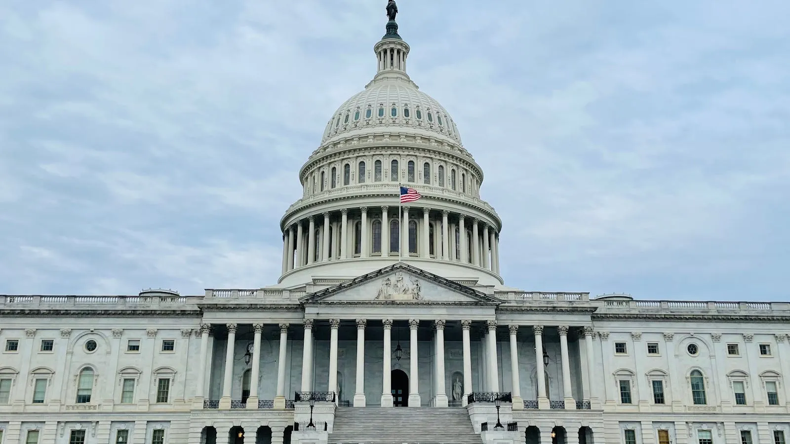 The dome and front facade of the U.S. Capitol building viewed from the lawn.