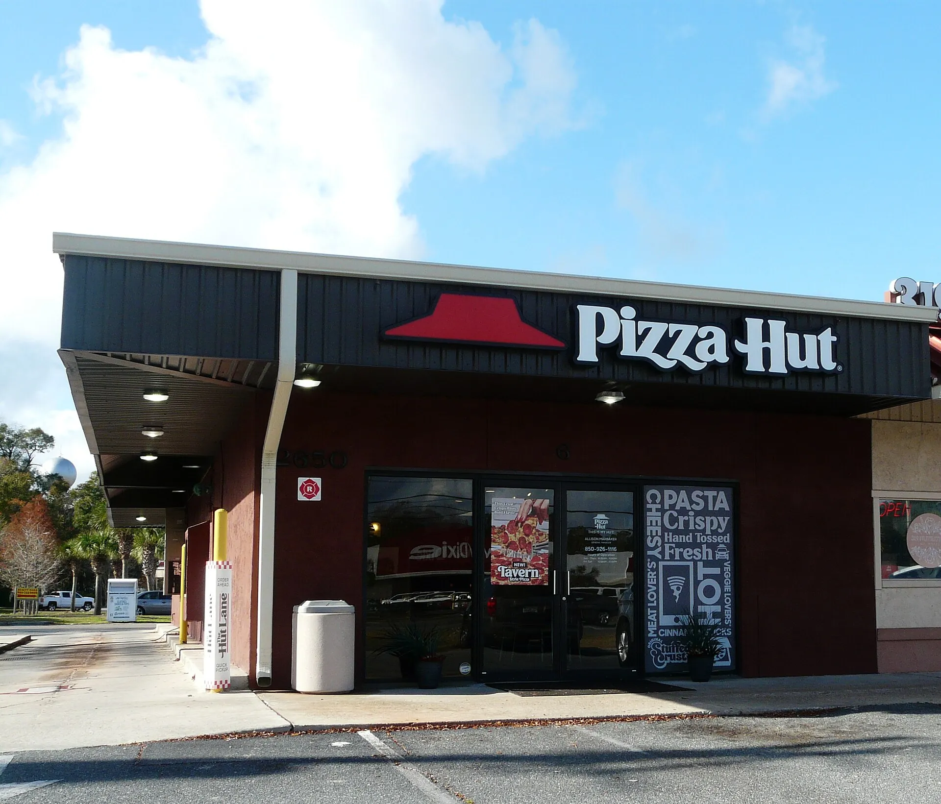 A Pizza Hut restaurant building with its red roof and signage in Crawfordville, Florida.