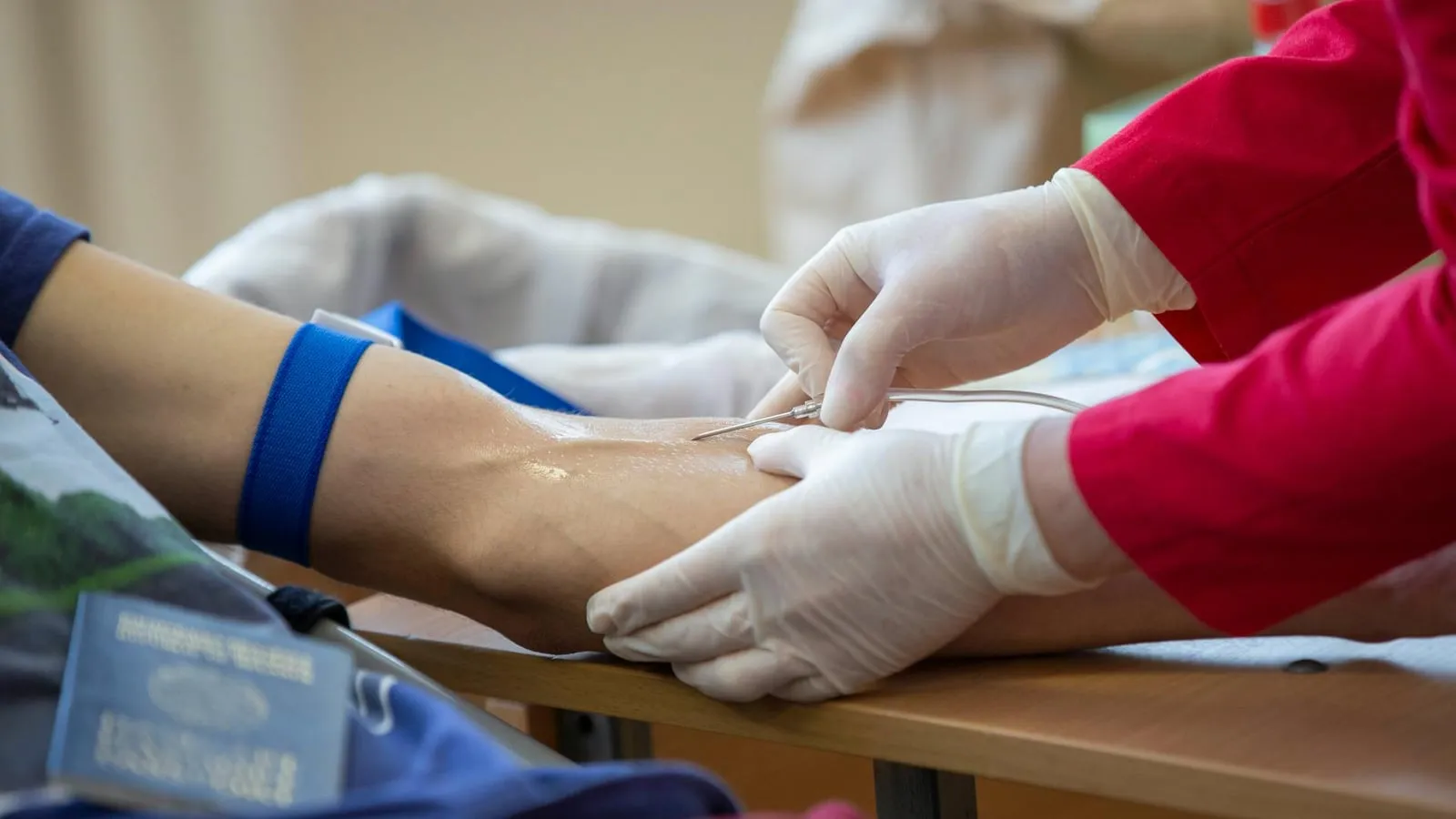 Close-up of a healthcare professional injecting a syringe into a patient's upper arm.