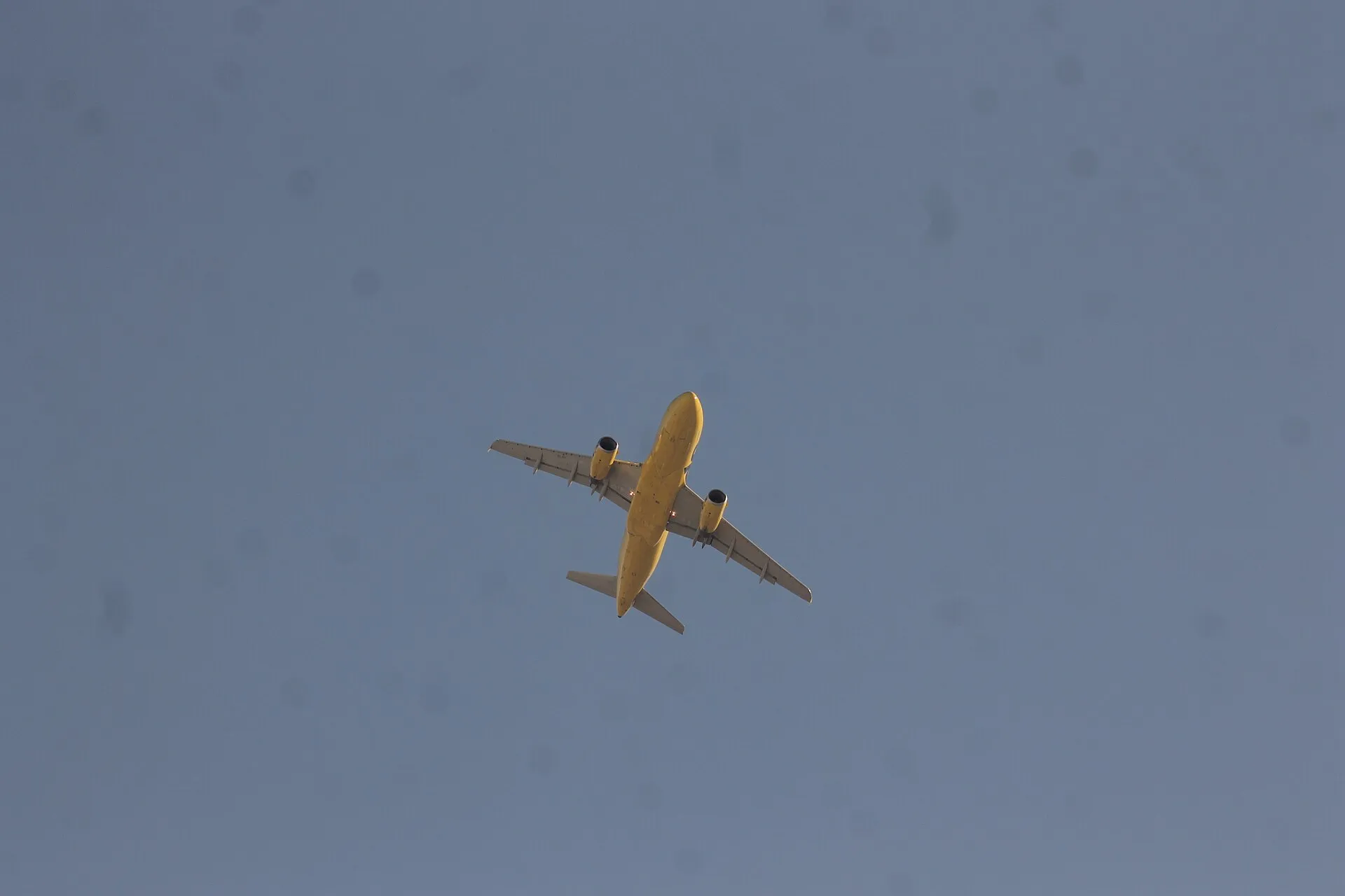 A Spirit Airlines Airbus jet in flight high above the desert landscape near Las Vegas.