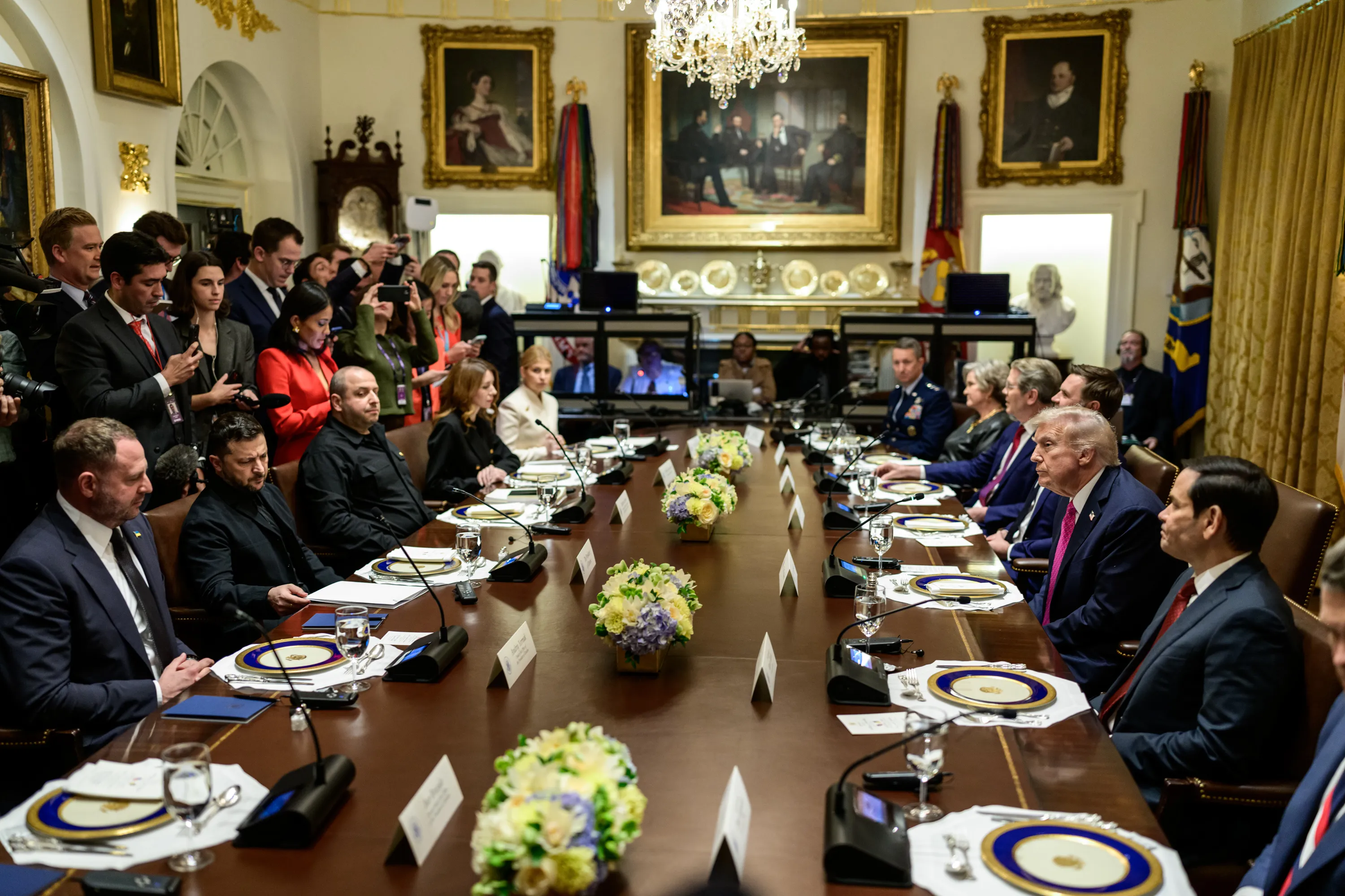 President Donald Trump and Ukrainian President Volodymyr Zelenskyy seated at a table during a meeting at the White House.