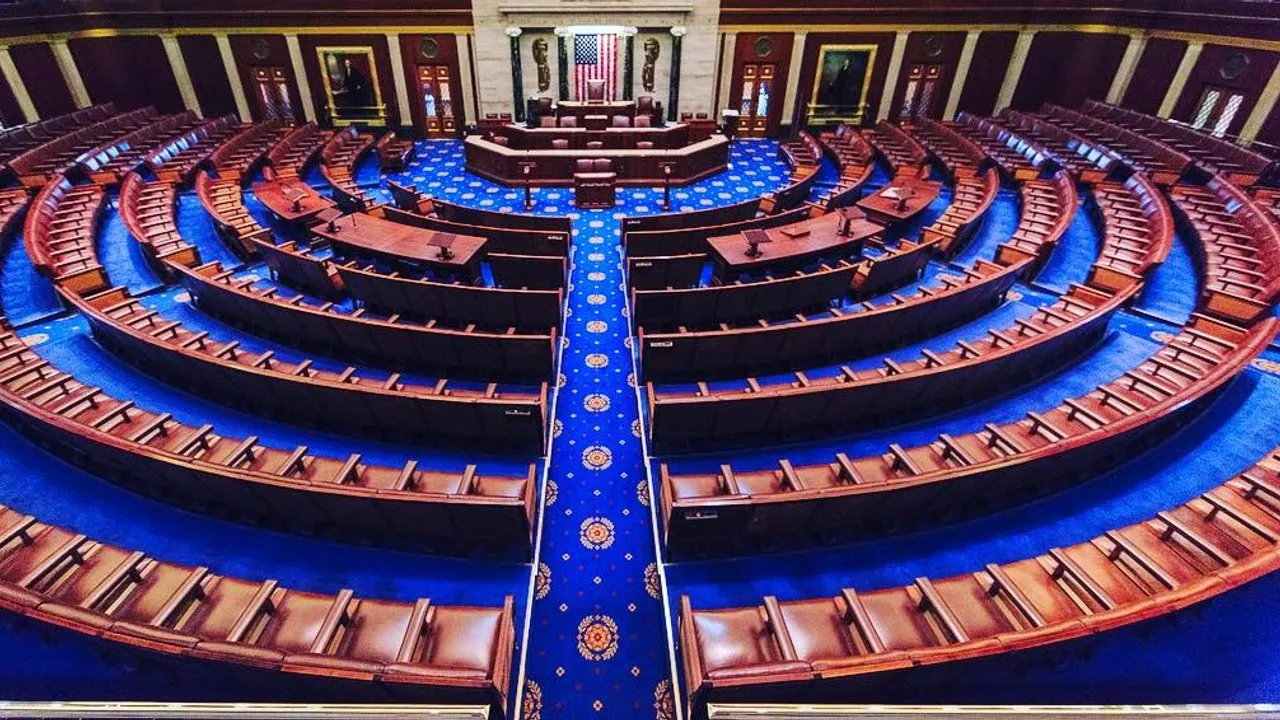 The empty chamber of the U.S. House of Representatives, viewed from the gallery above the rostrum.