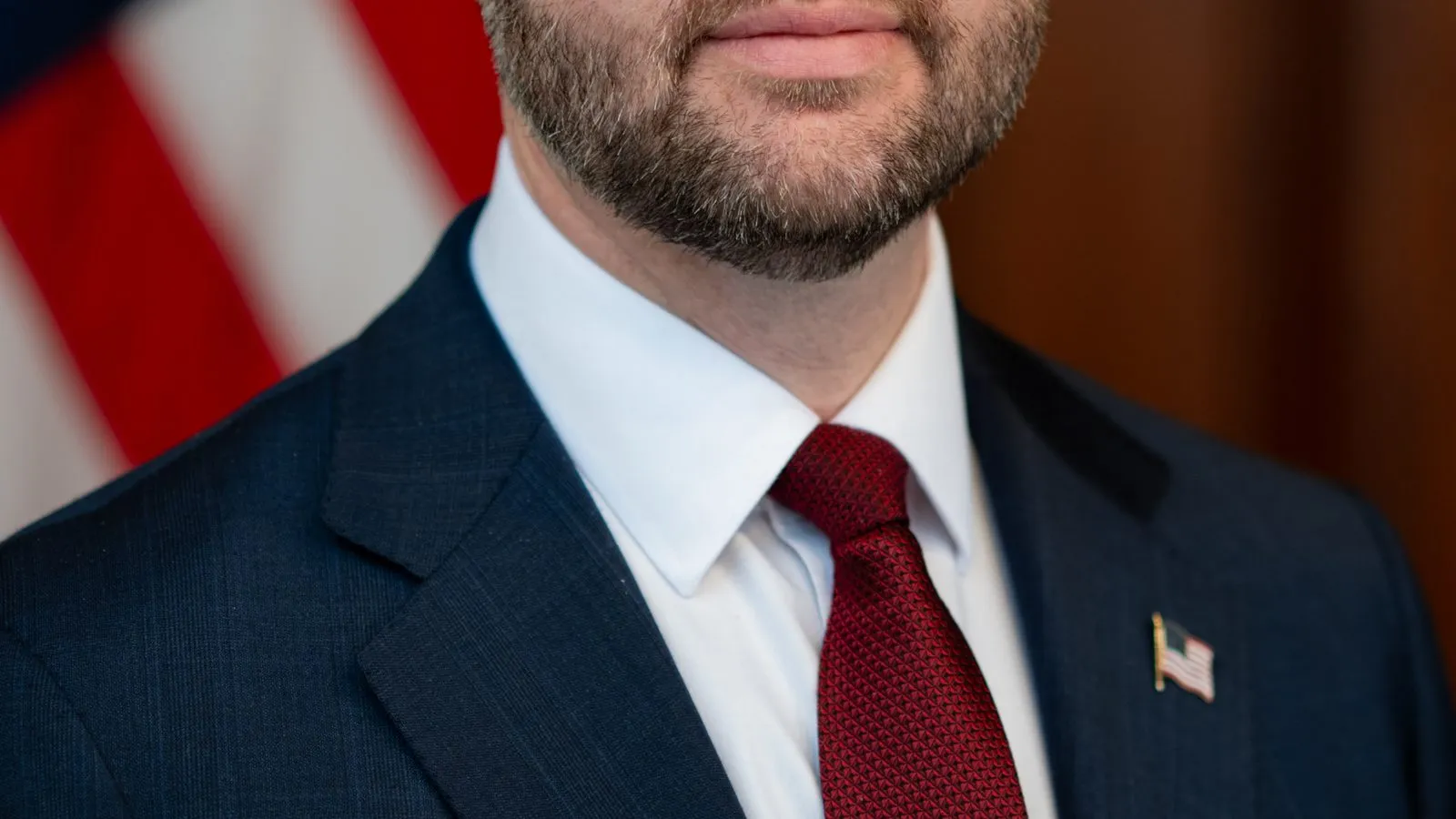 Vice President JD Vance in a dark suit and tie, posed for an official portrait.