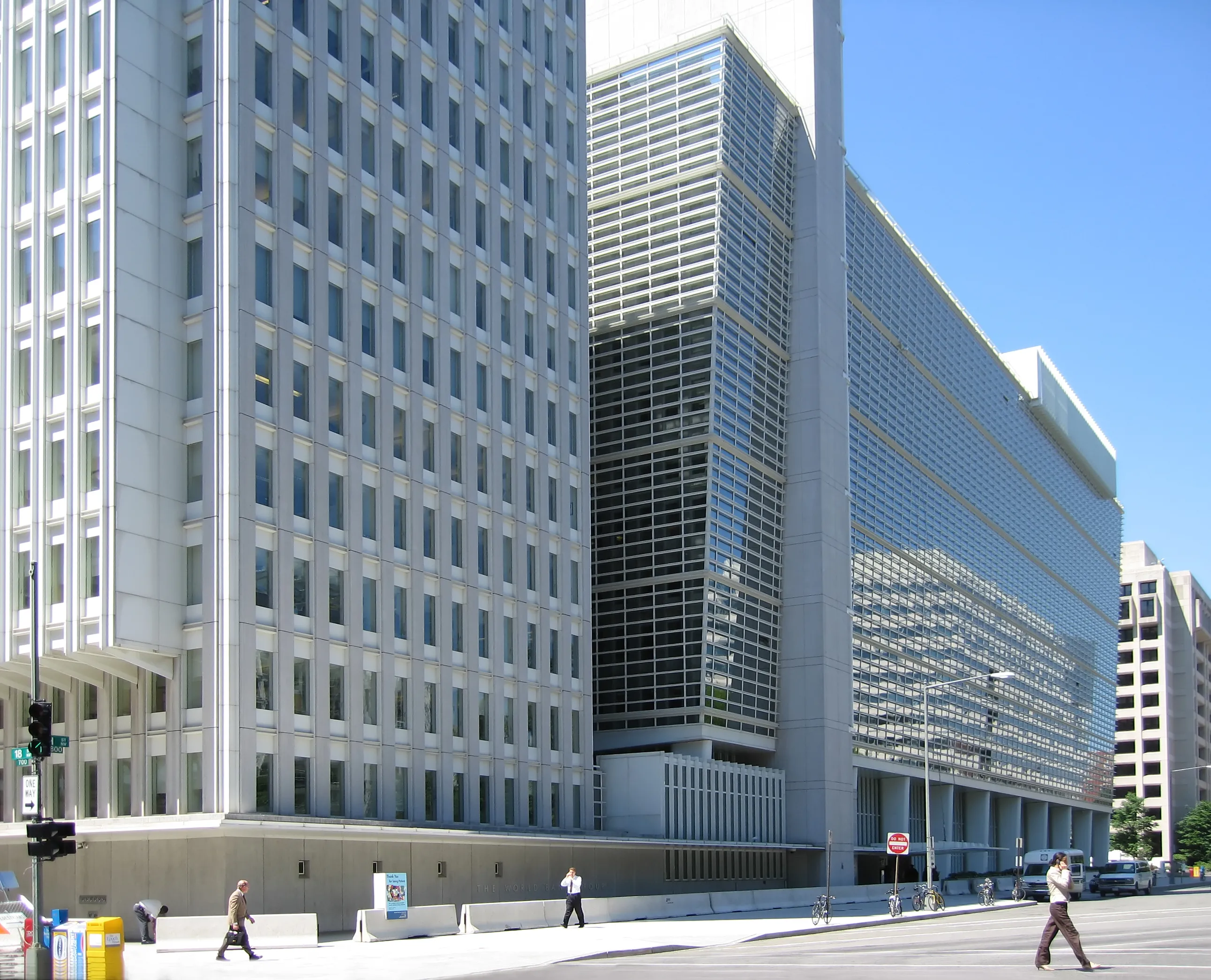 The curved stone-and-glass facade and flagpoles of the World Bank Group headquarters building in Washington, D.C.